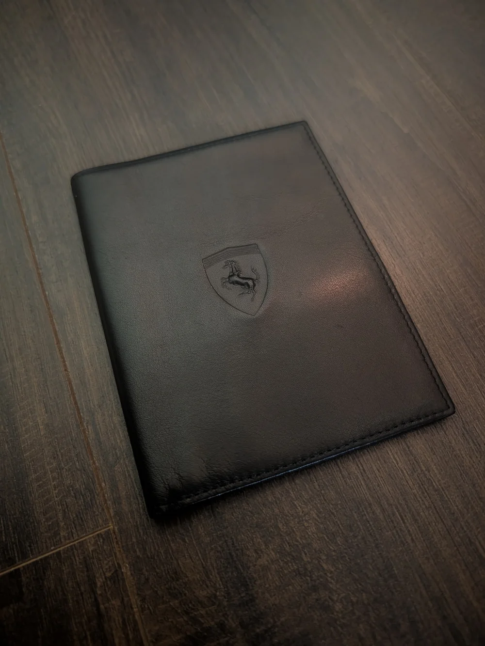 FERRARI Black Leather Passport Wallet with Embossed Shield Logo Red Inside